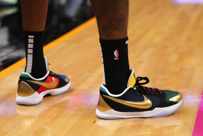 View of black and gold Nike Kobe shoes.